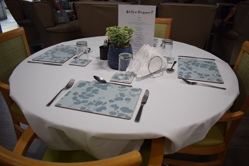 Dining table with utensils and menu in Roby House