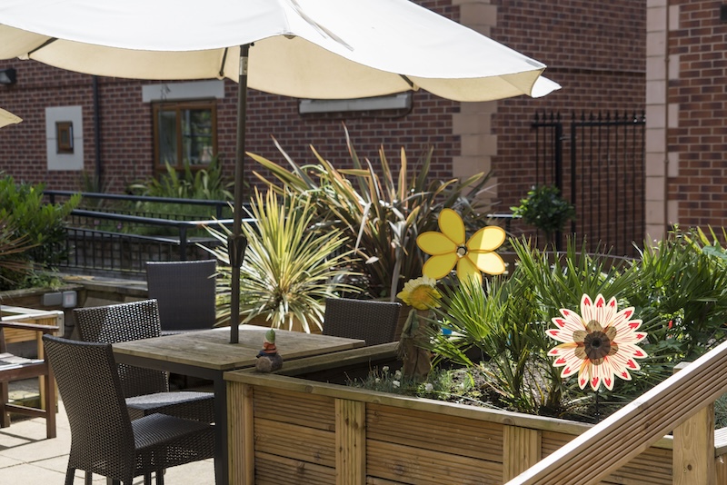 Table and chairs under an umbrella in the garden patio